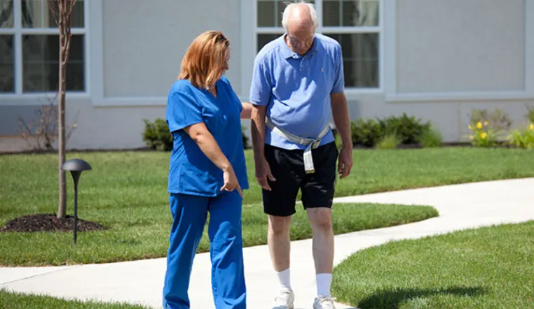 nurse and patient walking outside