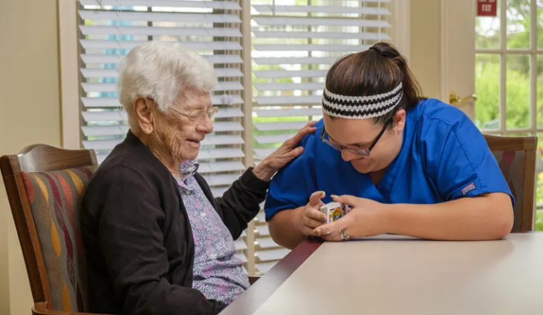 nurse and patient laughing playing cards