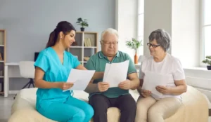 nurse and a family looking over paperwork