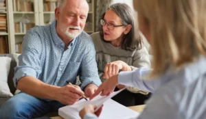 nurse showing paper to older couple
