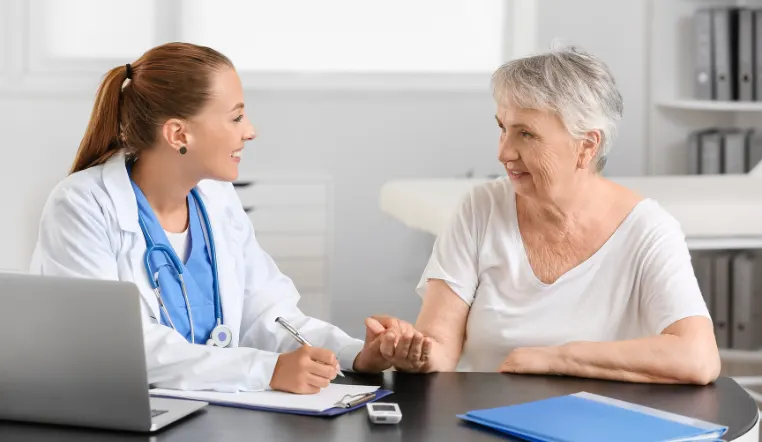 doctor and patient looking at each other smiling