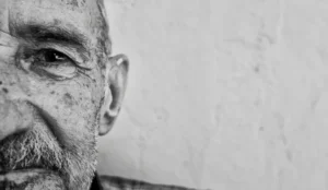close detailed view of half a older mans face