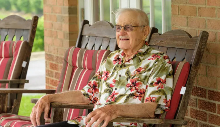 senior sitting on porch in a rocking chair