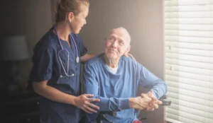 older man smiling at nurse