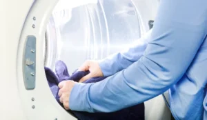 hands inside a dryer for laundry