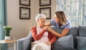 senior and nurse looking at each other smiling