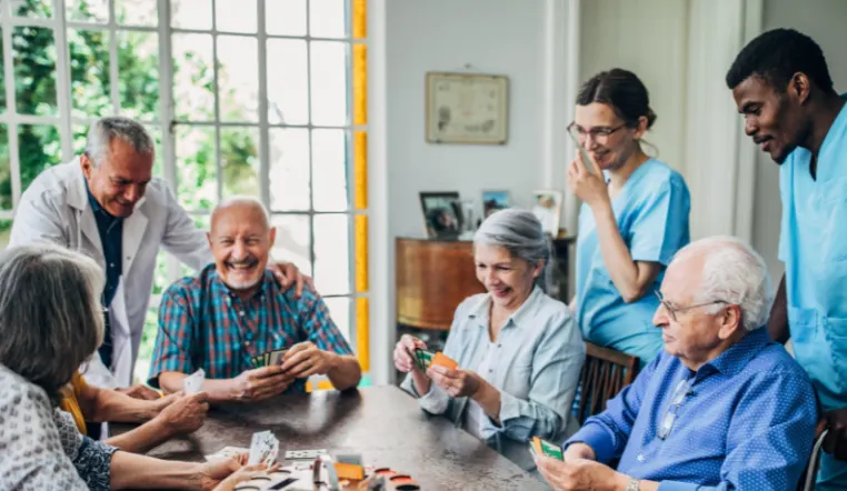 residents playing cards at a table