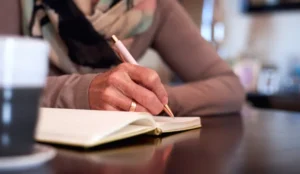 someone writing in a journal