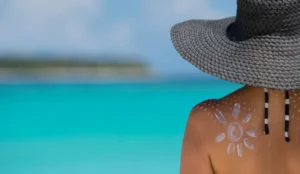 a lady with sunscreen on her back in shape of a sun