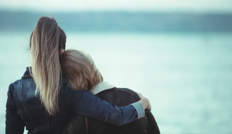 daughter and mother leaning into each other