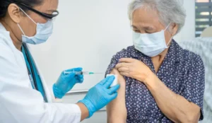 female getting a vaccine from doctor