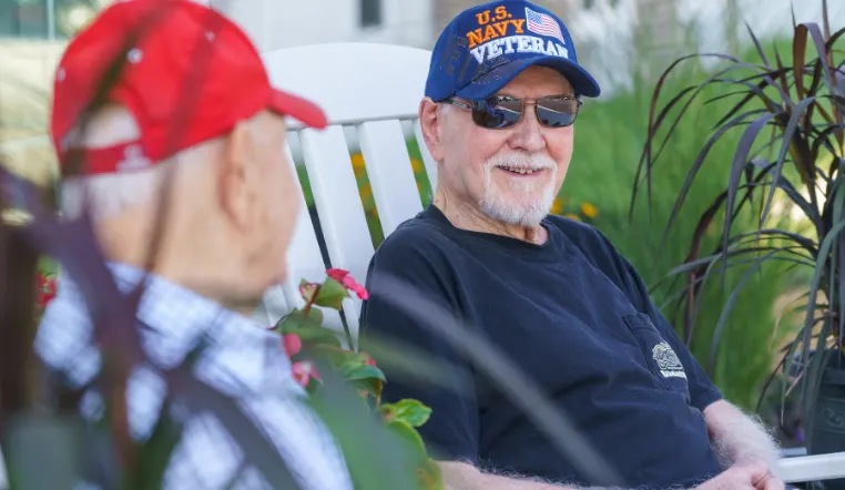 senior smiling at other resident