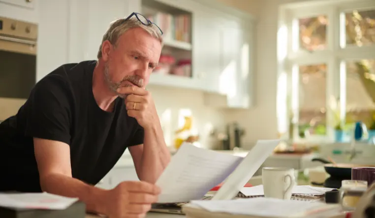 man overlooking paperwork