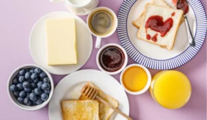 image of different foods like juice, blueberries, jam, bread