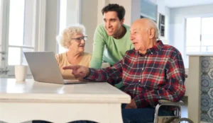son and senior parents looking at laptop