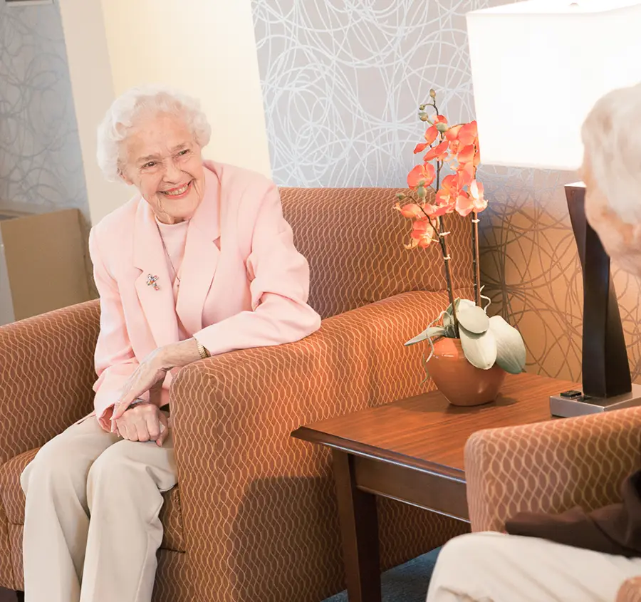 Senior assisted living resident speaking to a friend