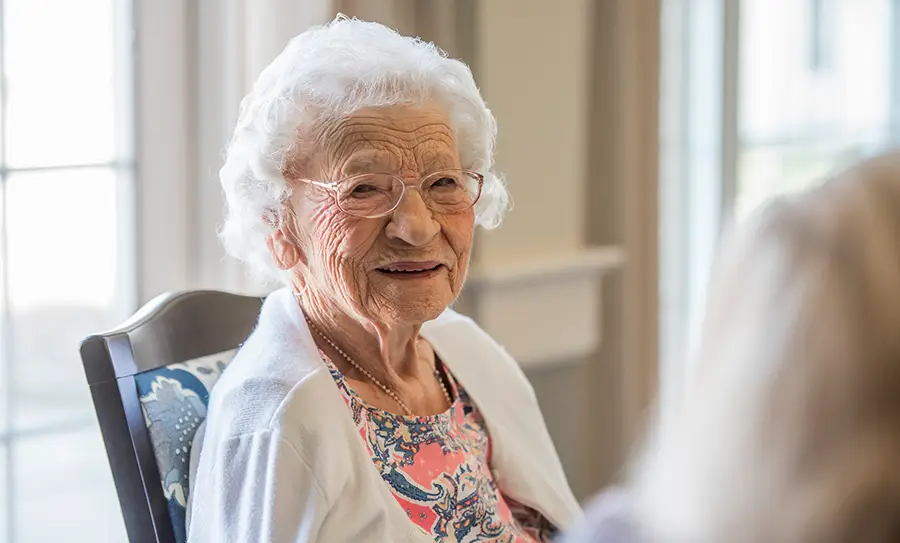 Senior woman with glasses smiling at camera