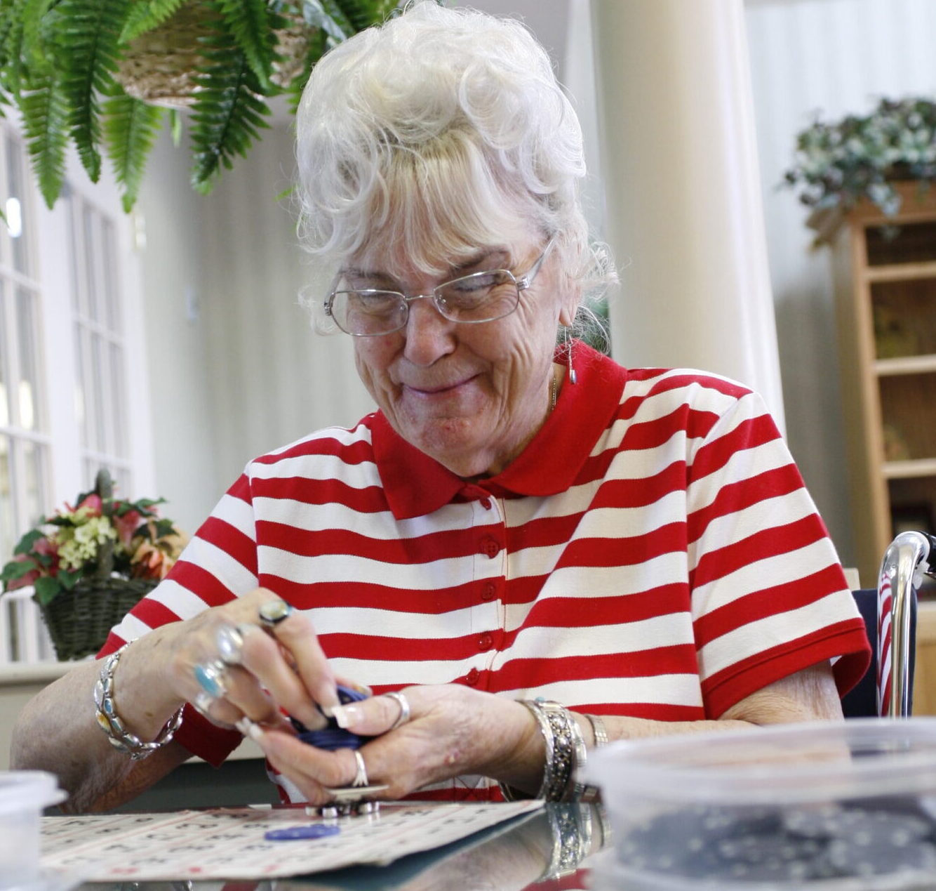 Woman counts out bingo chips in hand