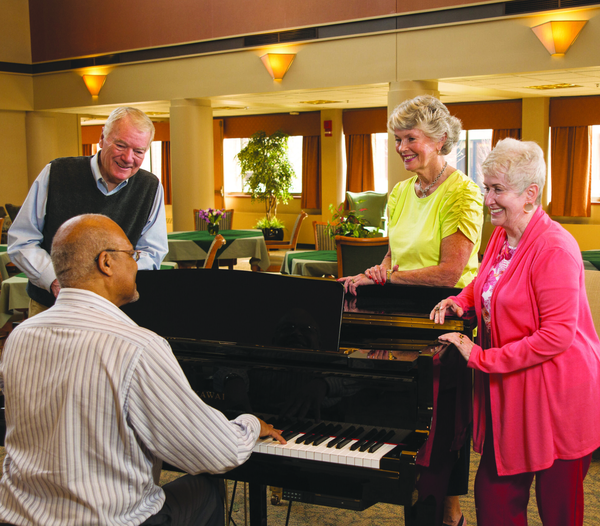 Residents gather around piano at Evergreen