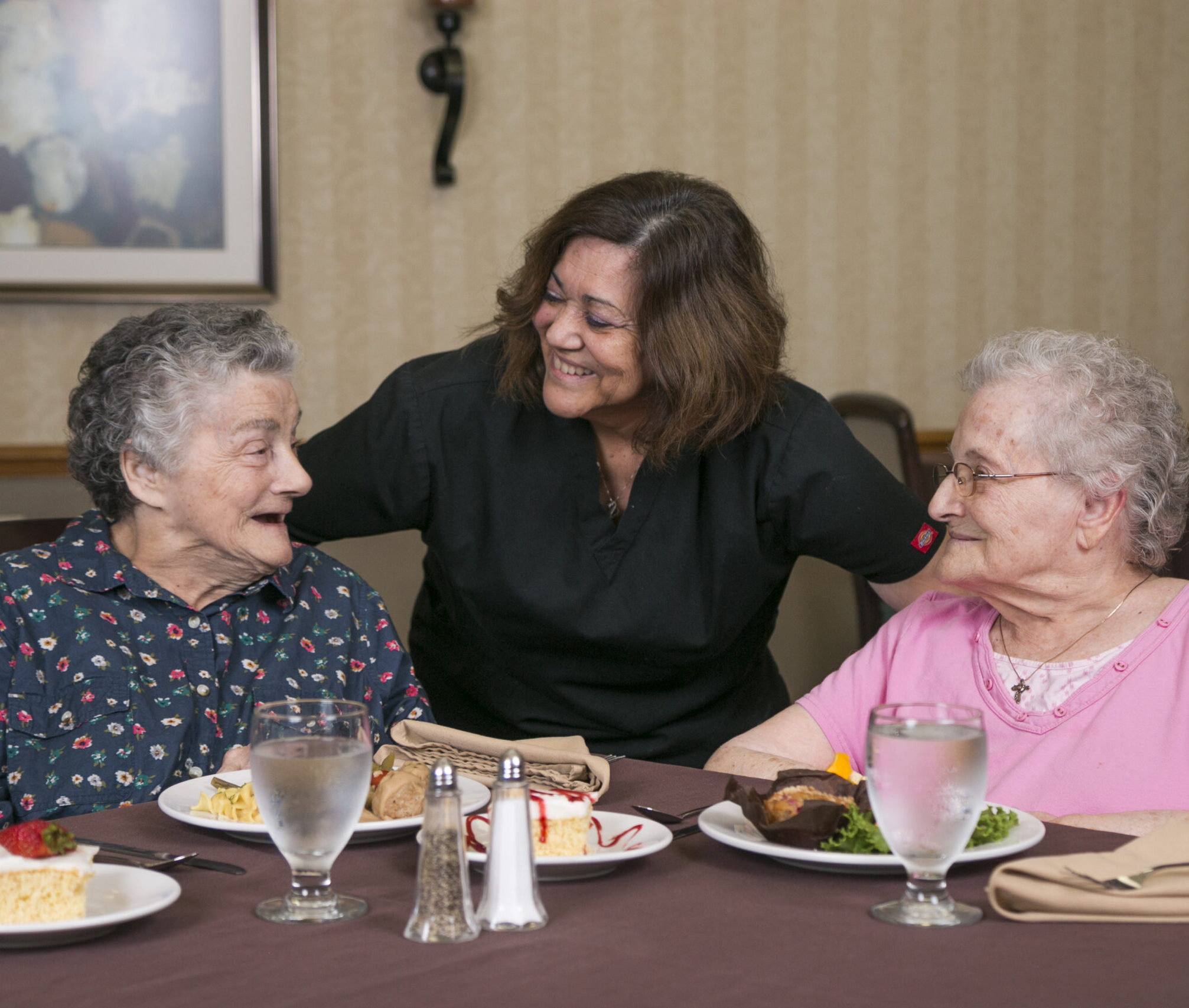 Two woman dining and speaking with chef