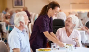 Seniors at a restaurant being served their meals