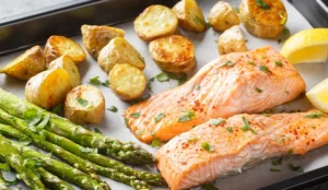 Pan of roasted salmon, potatoes, and vegetables with lemon